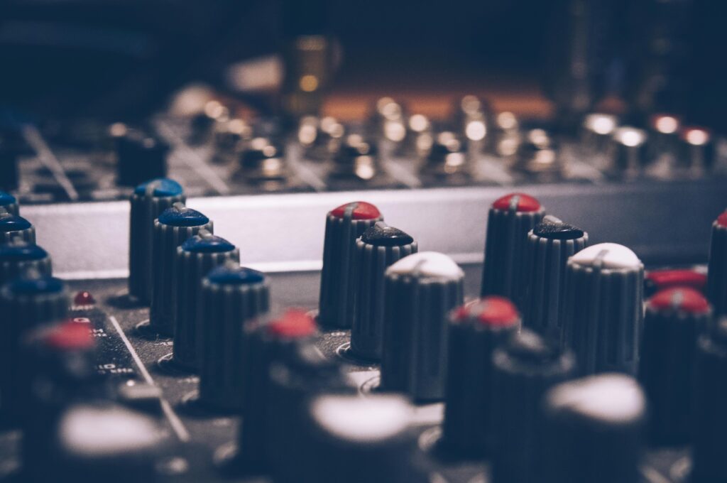 pexels-photo-744318-744318 Close-up of audio mixer knobs in a dimly lit studio. Perfect for music and technology themes.